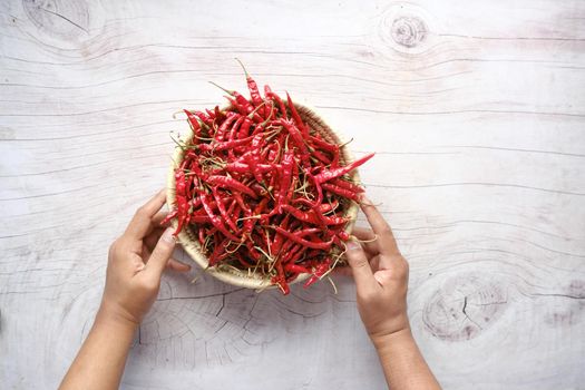 dried peppers in a a bowl on table .