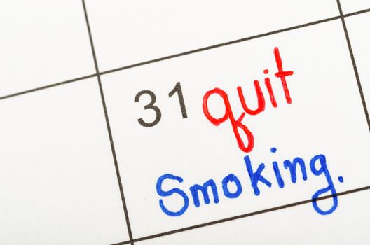 The words Quit Smoking written in calendar to remind you an important appointment.
