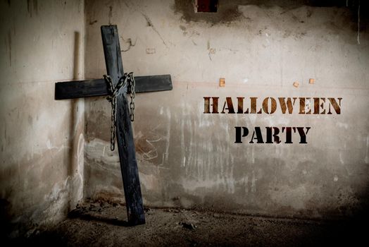 Black cross against the wall with hanging steel chain, Halloween party festival posture advertising. Halloween's Day and ghost concept. Dark and scary tone tone pinterest and instragram like process.