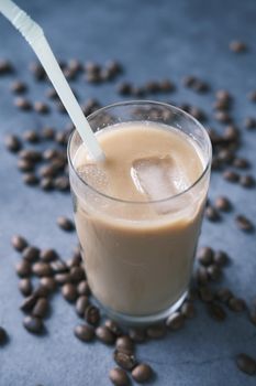 ice coffee in a tall glass on black background