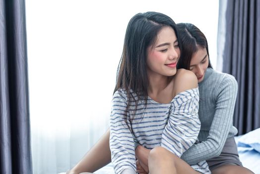 Two Asian Lesbian women hug and embracing together in bedroom. Couple people and Beauty concept. Happy lifestyles and home sweet home theme. Homosexual life theme. Love scene making of female