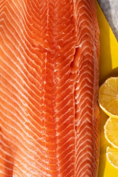 Salmon fish steak, prepared close up. Selective focus. Vertical photo