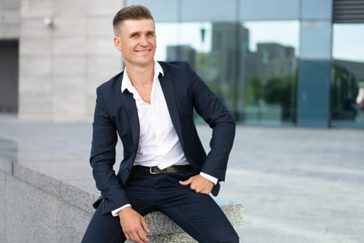 Business. Businessman Sitting City Street Office Building Handsome Caucasian Male Business Person Portrait Corporative Building Background Successful Young Adult Manager Dressed Business suit no tie
