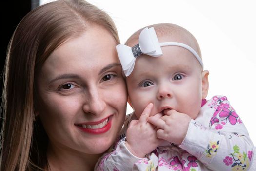 Portrait of a beautiful mother and little daughter.