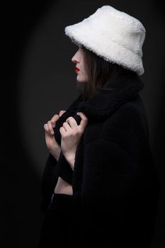 A beautiful girl in a white fur hat.