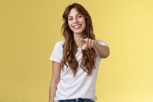 Only you. Friendly cheerful good-looking curly-haired girl picking join team found excellent candidate pointing camera extend index finger indicating forward smiling delighted made perfect choice.