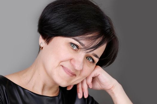 Portrait of a beautiful middle-aged woman. European style blue eyed brunette