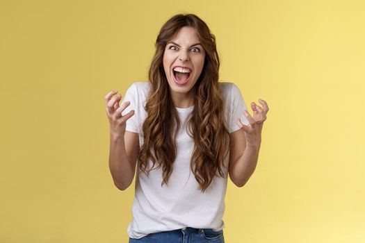 Girl hates gets annoyed freak out starting arguing bad day work. Outraged pissed irritated curly-haired woman cringe yelling bothered squeez fists anger complaining arguing scream hateful.