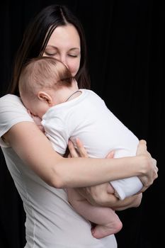 Beautiful mother hugs her baby. Motherhood.