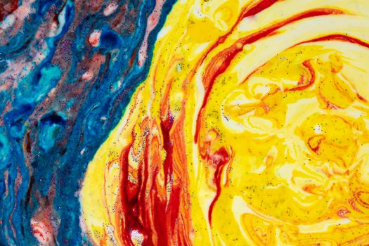 Bright blue acrylic stain with bright yellow. Marble colorful texture. A semicircle smeared with paints that looks like a celestial mantle. Abstract painting.