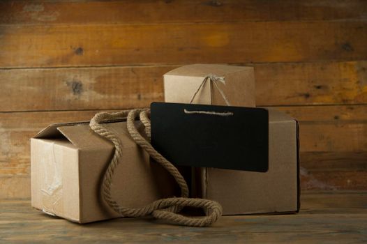 Pile cardboard boxes on a wooden background. Сargo delivery
