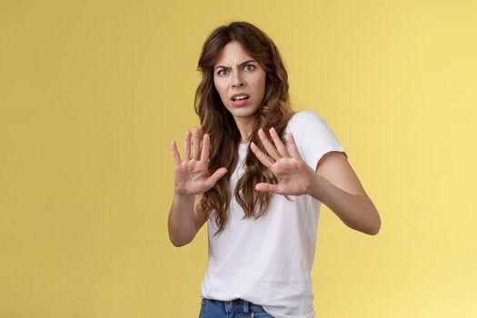 Back up I said no. Ignorant bothered displeased intense serious woman cringe grimacing disgusted step back hold hands stop enough rejection gesture express aversion demand not come closer.