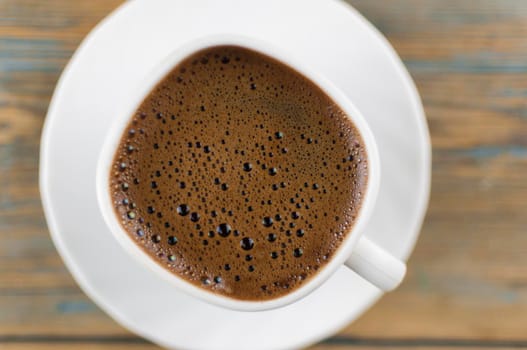 Top view of coffee cup on a wood background with copy space. Close up