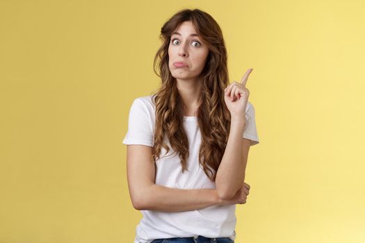 Hmm interesting advice thanks. Girl raise index finger pulling face not bad eureka gesture found great plan say suggestion make eureka sign stand yellow background share good recommendation.
