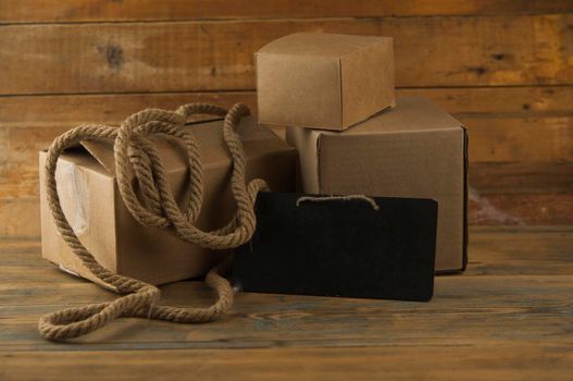 Pile cardboard boxes on a wooden background. Сargo delivery