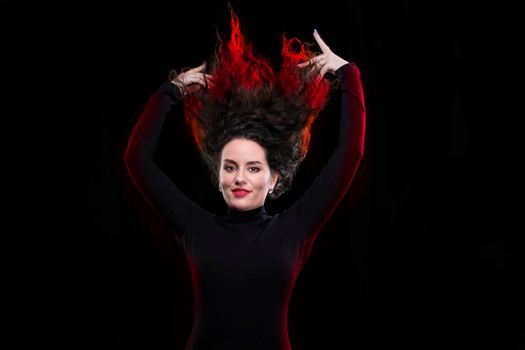 The brunette woman tossed up her hair, which is highlighted in red.