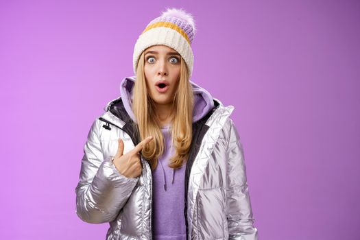 Frustrated shocked speechless stunned blond woman accused widen eyes surrpised questioned look camera pointing herself cannot believe being picked blame victim, standing purple background.