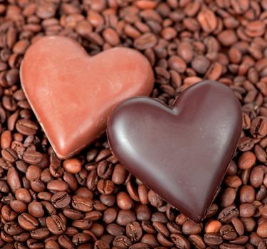 Coffee beans heart with heart-shaped candy .