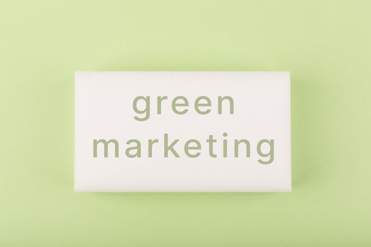 Green marketing minimal concept in monochromatic green colors. Green marketing text written on white rectangle on green background decorated
