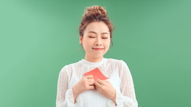 Happy asian girl getting gifts on valentine's day