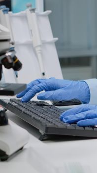 Scientific doctor analyzing sample of blood from vacutainer in laboratory. Specialist woman using flask with liquid for genetic testing. Chemical glassware in lab science industry