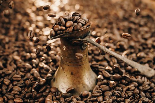 Turkish Coffee Pot and Coffee grains are scattered on the beans surface