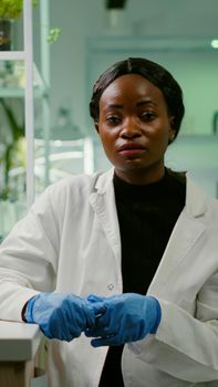 Pov of botanist researcher woman explaining botany experiment during online videocall meeting while sitting in pharmaceutical lab. Specialists team researching genetic mutation developing dna test