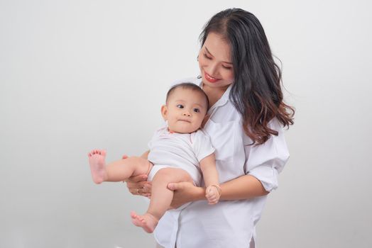 Safe in his mother's arms. Mother and her baby girl at home.