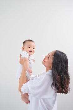 Safe in his mother's arms. Mother and her baby girl at home.