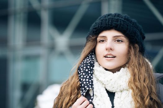 Close up portrait of caucasian young woman takes off mask standing at outdoor. Healthcare. Safety measures concept. End of pandemic. Winter outdoor curly girl. Female breathes deeply looking at camera