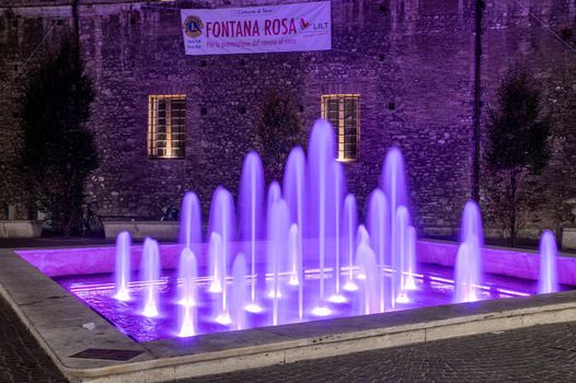 terni,italy october 12 2021:fountain of the town of terni illuminated in pink