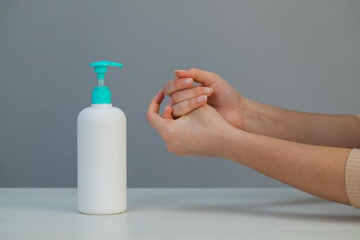 A girl using alcohol gel for cleaning hands. Sanitiser Gel for Clean Hands Hygiene Corona Virus Spread Prevention. Woman Using Alcohol Rub Alternative to Washing Hands.
