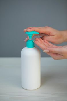 Female hands using alcohol gel sanitizer at shopping center for prevent the spread of germs and bacteria and avoid infections corona virus.