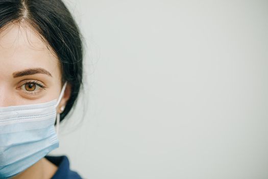 Health Protection Corona Virus Concept. Young woman in medical mask. Female breathes deeply and looking at camera.