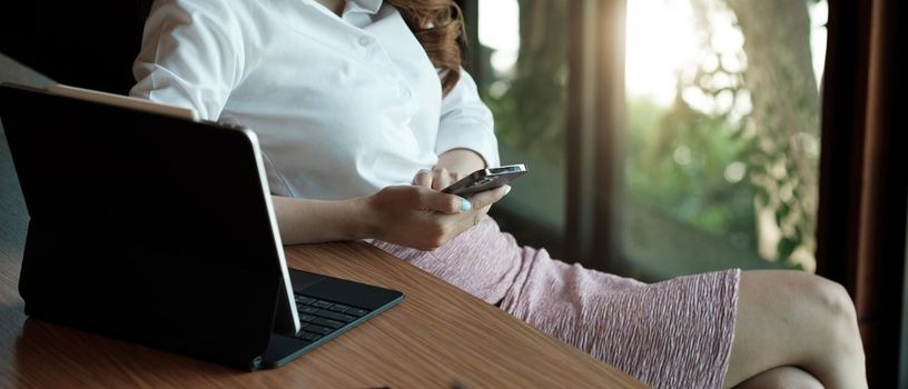 Close up hand of woman using smartphone, texting text message, hipster touch screen on smartphone light bokeh, girls using in hands cellphone close up, online internet.