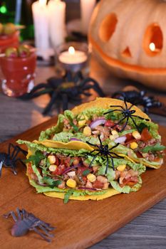 Halloween Food. Mexican corn tortilla tacos with vegetables and chicken. Add some burning gustatory color to your party