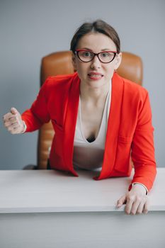 Nervous business woman blogger vlogger influencer sit at home speaking looking at camera.