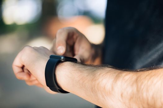 Young man trying new smart watch. Smart watch. Man Using Smart Watch. Closeup