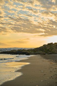 Morning, sunrise at sea, natural seascape, the Greek city of Chania Crete on the horizon.
