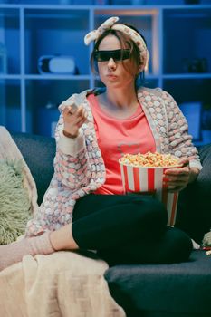 Positive woman in 3d glasses eating popcorn. Fun young woman in 3d glasses watching movie film, eat popcorn. People sincere emotions in cinema, lifestyle concept