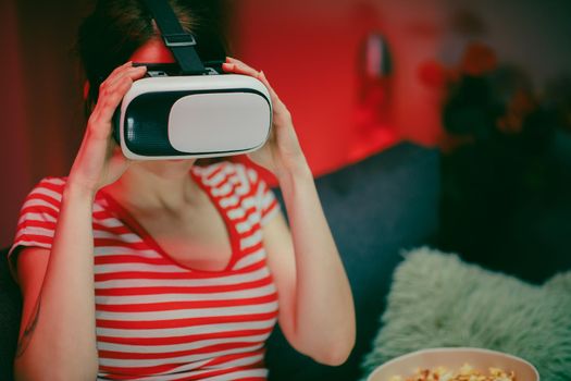 Emotional woman wear VR headset playing video game. Woman relaxing playing video games using vr headset. Caucasian female gamer.