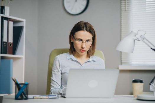 Businesswoman Working on a Laptop in Her Office. Strong Independend Female CEO Runs Business Company.