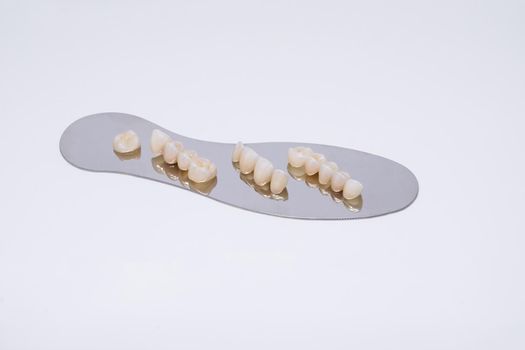 Metal free ceramic dental crowns. Zirconium tooth crown Isolate on wite background. Aesthetic restoration of tooth loss.