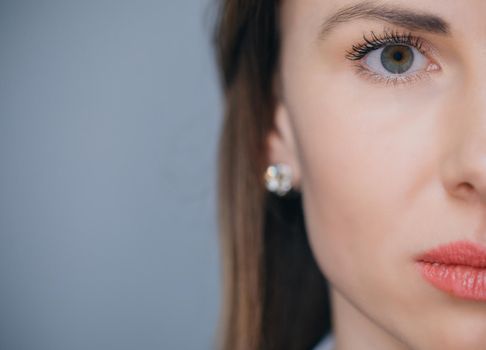 Close up of female face isolated on background with copy space. Beautiful Young European Girl.