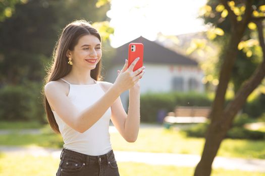 Young girl vlogger waving hand speaking looking at camera webcam. Girl communicating with friend online make video call talking record lifestyle vlog distance job interview