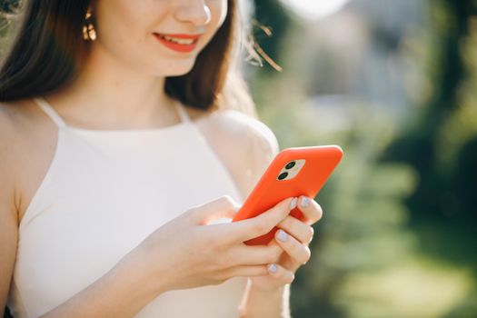 Woman using mobile smart phone in the park. Mockup image of a woman using smart phone at outdoor.