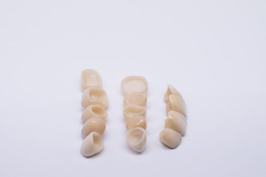 Metal Free Ceramic Dental Crowns. Zirconium tooth crown isolate on wite background. Aesthetic restoration of tooth loss. Ceramic zirconium in final version.