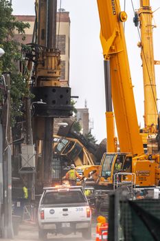 Chicago, IL - October 6th, 2021: A pickup truck from the CTA pulls down a dusty alley accross from the accident scene where a construction crane tipped over doing work near the train tracks.