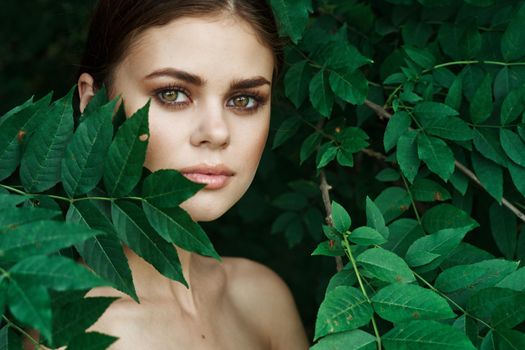 portrait of a woman green leaves clean skin nature summer model. High quality photo