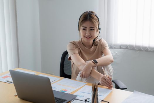 Businesswoman in having a video call on laptop while discussion with business partner during work from home